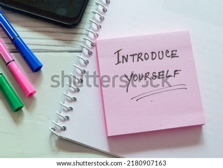 Sticky note with the text Introduce yourself on office desk. Self-introduction concept. Royalty-Free Stock Photo #2180907163