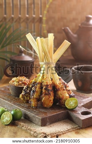 Sate lilit is a satay variant in Indonesia, originating from Balinese cuisine. This satay is made from fish, chicken, which is then mixed with grated coconut,  lemon juice, shallots, and pepper. Royalty-Free Stock Photo #2180910305
