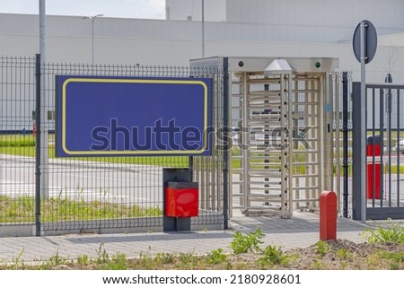 Workers Entrance Turnstile Doors at Factory Gate Fence