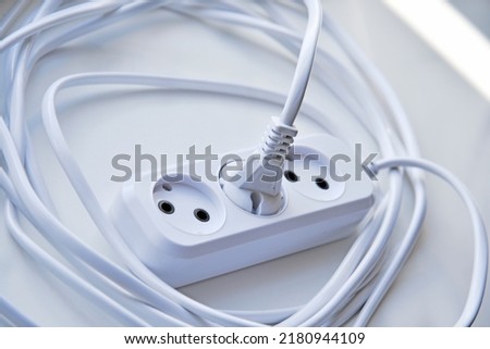 White electric extension cord, great design for any purposes. White background. Network extension cord.
