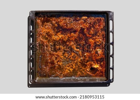 Metal sheet for baking in the oven with the rest of fatty food and oil Royalty-Free Stock Photo #2180953115