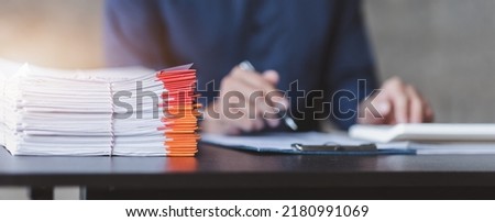Business Documents, Auditor businesswoman checking searching document legal prepare paperwork or report for analysis TAX time,accountant Documents data contract partner deal in workplace office Royalty-Free Stock Photo #2180991069