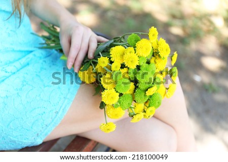 Beautiful bouquet of chrysanthemums flowers on wooden bench in park 