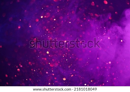 Colorful smoke clouds and shiny glitter lights bokeh abstract fantasy background