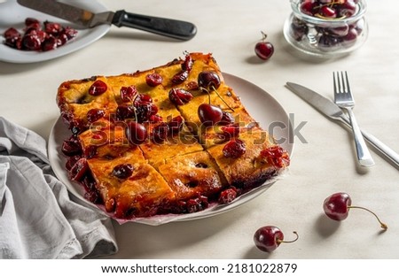 Fresh baked sweet cherry pie or red brownie cake on plate. Raw berries, piece of cake and milk in the picture
