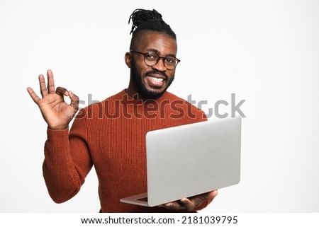 African-american young freelancer businessman student boss working remotely on laptop, watching webinars online, showing okay gesture isolated in white background