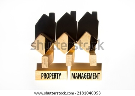 Property management symbol. Concept words Property management on wooden blocks on a beautiful white table white background. Wooden house model. Business property management concept. Copy space.