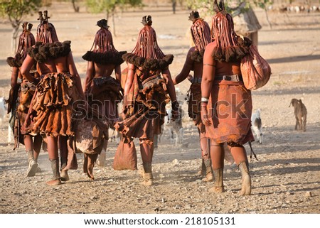 Himba women go back to the village near Opuwo town in Namibia, South Africa Royalty-Free Stock Photo #218105131