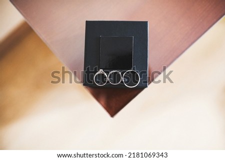 Three wedding rings in a black box.