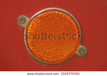 one red round plastic reflector on the metal wall of the trailer Royalty-Free Stock Photo #2181070581