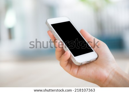 Hand touch the Screen on the Smart Phone Royalty-Free Stock Photo #218107363