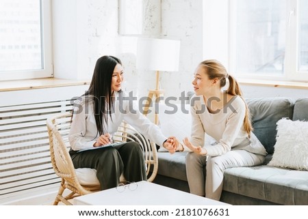 psychological consultation young Asian specialist psychologist or coach conducts a session for a patient of a young woman, problem solving, mental health Royalty-Free Stock Photo #2181076631