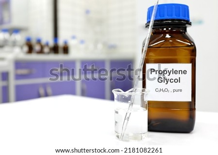 Selective focus of propylene glycol liquid chemical compound in dark glass bottle inside a chemistry laboratory with copy space. Royalty-Free Stock Photo #2181082261