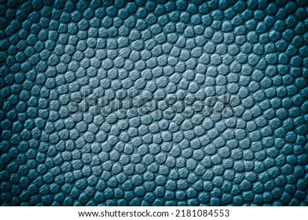 Genuine leather texture, dark blue color, matte grainy surface,rendy background witch vignette. Copy space. Concept of shopping, manufacturing