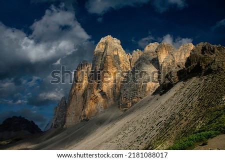 Sunset at the famous three peaks of Lavaredo, The Tre Cime di Lavaredo also called the Drei Zinnen are three distinctive battlement-like peaks, in the Sexten Dolomites of northeastern Italy Royalty-Free Stock Photo #2181088017
