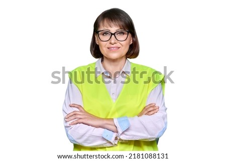 Portrait of industrial woman in safety vest looking at camera on white isolated background