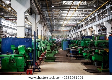 Industrial workshop for production of handling removable devices. Perspective of the old machine tool equipment at empty clean workshop. The interior of the metalworking shop. Industrial enterprise Royalty-Free Stock Photo #2181089209