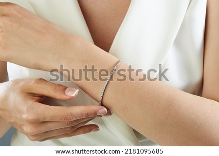 Diamond jewelry. Diamond bracelet on young woman Royalty-Free Stock Photo #2181095685