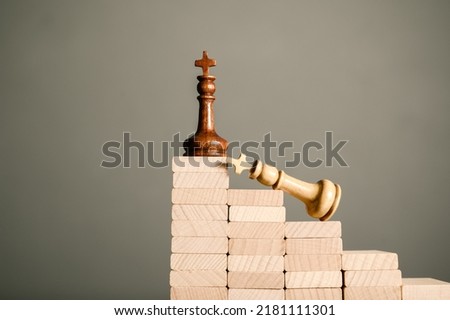 Winner king chess get to the top stage while the opponent is struggle at the lower level, competition concept Royalty-Free Stock Photo #2181111301
