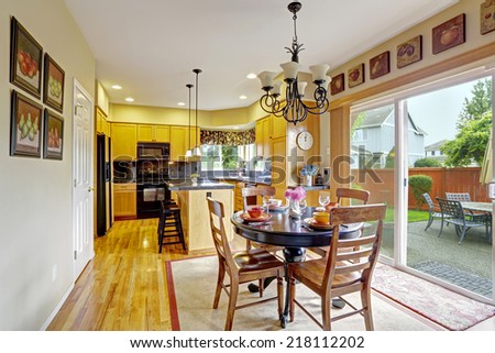 Bright dining area in kitchen room with exit to backyard patio
