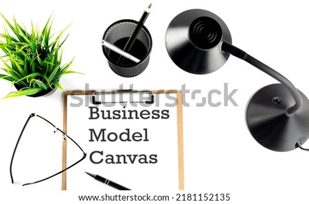 BUSINESS MODEL CANVAS text on a clipboard on the white background