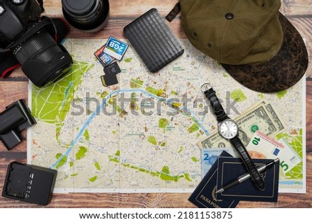 City maps next to cameras and passport on a wooden table. Concept of vacations, travels, travelers, Copy space.