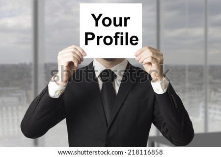 businessman hiding face behind sign your profile