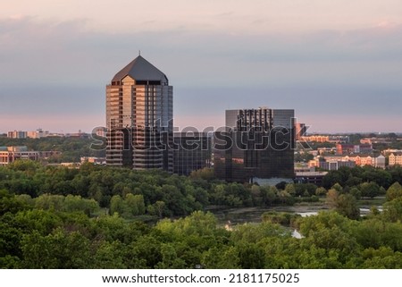 A Telephoto Shot Compressing Part of the Bloomington, MN Skyline with Lake Normandale under Warm Sunset Light Royalty-Free Stock Photo #2181175025