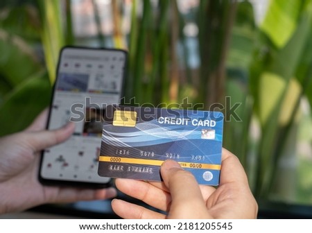 Women with credit cards and using mobile phones to shop online.