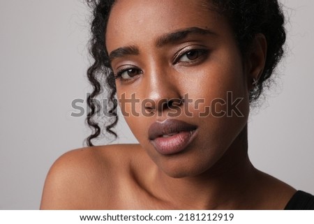 Close-up portrait of African American young woman looking at the camera. Mock-up