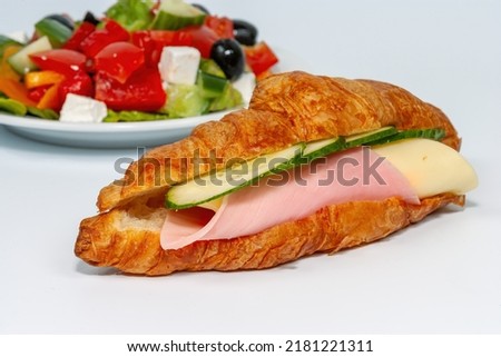 Croissant with ham and cheese with Greek salad, isolate on a white background