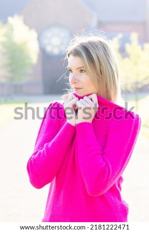Portrait of nice attractive charming girl touch hands face enjoy weekend, wear green style stylish trendy clothes against a green color natural background. High quality photo