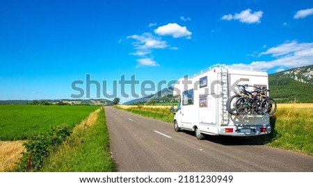 family road trip travel- camper van traveling, motorhome on the road Royalty-Free Stock Photo #2181230949