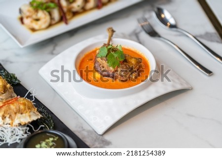 duck leg confit in red curry Royalty-Free Stock Photo #2181254389