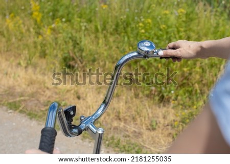 woman pulling the trigger of a bicycle bell. High quality photo