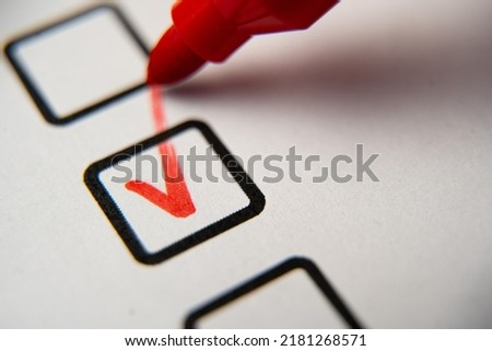 Check the box in the checklist with a red marker. Completed and completed task, obligation, obligation or responsibility