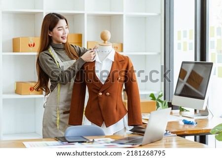 Professional decorator Asian female person working with fabric color swatches, working in the office. Startup designer concept.