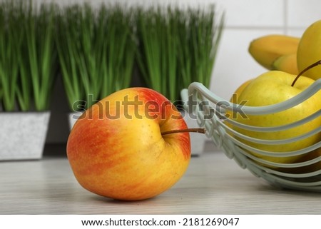 Fresh apples on white wooden table, closeup