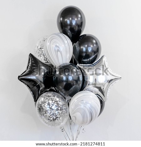 A set of black and silver balloons with helium. Concept of holiday, happy birthday.