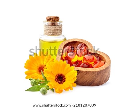 Vitamin capsules with calendula flowers and oil.