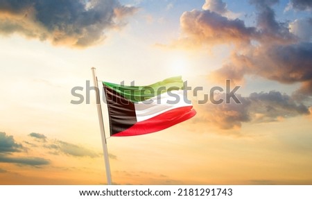 Kuwait national flag waving in beautiful clouds. Royalty-Free Stock Photo #2181291743