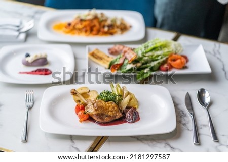 duck leg confit on the table  Royalty-Free Stock Photo #2181297587
