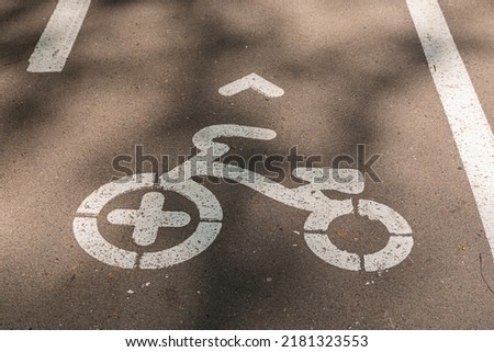 Sign for cyclists on the path in the park. Bicycle road.
