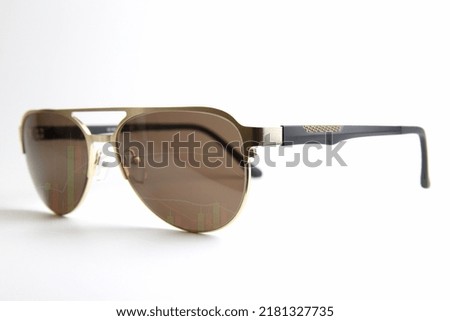 sunglasses and stock graph overlay, growing eyewear business idea. Sunglasses on white 