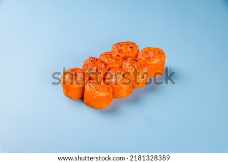 california roll with baked salmon and shrimp on blue background