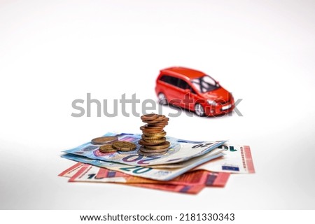 red car, euro banknotes and coins isolated on white background with clipping path, insurance concept