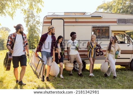 A group of cheerful friends set off on an RV trip. The students have arrived at their destination and are enjoying their time together.