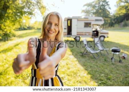 A pretty blond girl is happy traveling in an RV.
