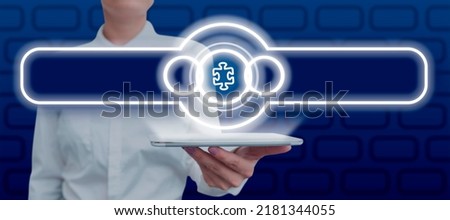 Businesswoman Holding Tablet Presenting Futuristic Display With Jigsaw Piece Symbol Showing Solutions. Woman Holding Pad Presenting Important Information And Strategies.