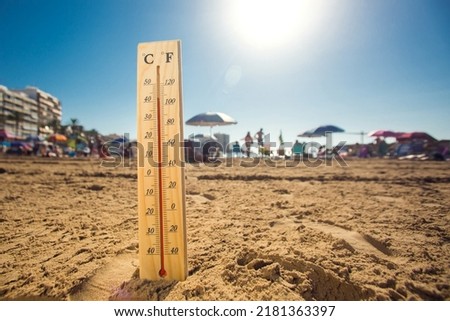Hot weather. A temperature scale on a beach shows high temperatures during a heat wave. Hot summer and climate concept Royalty-Free Stock Photo #2181363397